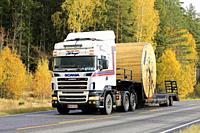 Scania R500 truck Kuljetus Karru Oy transports large wooden Prysmian Group cable reel on gooseneck trailer along road. Salo, Finland. October 11, 2019...