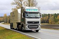 Silver Volvo FH truck of Okline Oy pulls Saint-Gobain glass trailer along rural highway on a day of autumn. Salo, Finland. October 11, 2019.