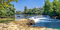 Manavgat waterfall and river in Antalya province of Turkey on a sunny summer day.