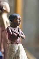 Cairo, Egyptian Museum, statuette of Iby, in wood. He's got short hair, a loin cloth, and crossed arms.