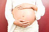 Pregnant woman in underwear isolated on red background. Mom Waiting to meet a baby as unborn, lovely and healthy concept