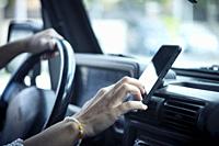 Close up of woman hand setting the gps online navigator on the phone while drive - people and travel with technology help to find the way - using app ...
