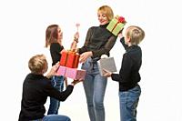 Children give a gift to mom, boys give a gift in boxes, flower girl.
