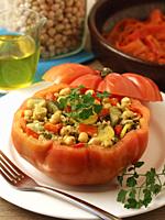 Stuffed tomato with vegetable mix with bulgur wheat, chickpeas and seasoning.