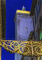 Christmas Holiday Decorations Stores Shops Narrow Street Old Clock Tower Nimes Gard France. Rebuilt in 1700s originally a 1500s belfry.