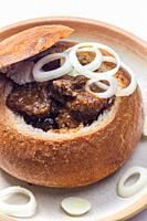 beef goulash in loaf of bread.