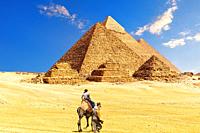 The Great Pyramid complex and bedouin with tourists in the Egypt desert, Giza.