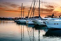 Luxury yachts moored in the Marina of Denia at sunset. Alicante, Spain.