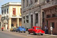 Old American cars used as taxi in front of the colonial buildings in Vedado district, Havana, La Habana, Cuba, West Indies, Central America.