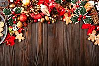 Christmas background of tray with gingerbread cookie men on wooden table.