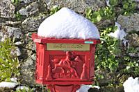 Vintage red mailbox under the snow.