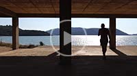 Ksamil, Albania A man walks on a concrete floor in an unfinished building on Lake Butrint.