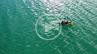 Young couple paddling an inflatable canoe in a swamp. Drone view. 4K. Alloz reservoir, Navarra, Spain, Europe