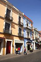 People in front of the colorful colonial buildings with balconies at the historic center, Puebla, Puebla State, Mexico, Central America.