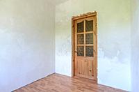 View of the front door in a small room after renovation.