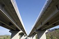 Photographic documentation of a stretch of motorway on reinforced concrete pylons.
