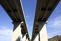 Photographic documentation of a stretch of motorway on reinforced concrete pylons.