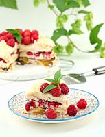 Round meringue pie with fresh raspberries on a white background, Pavlova dessert.