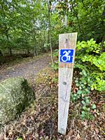 Signpost in a nature trail for the disabled with a wheelchair in Snogeholm recreation area in Sjöbo municipality, Scania, Sweden, Scandinavia.
