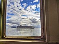 A large cruise ship in the Puget Sound as seen from inside another vessel.