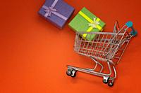 Colorful boxes in a shopping cart objects on an orange background, for promotional advertising sales promotion online shopping sales promotion.