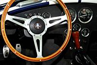 View the steering wheel and interior of a replica AC Cobra.