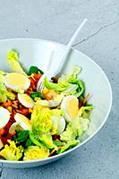 Fresh and healthy salad in a white bowl.