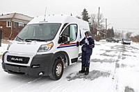 Detroit, Michigan, USA - 23 December 2022 - Deborah Williams delivers the mail during a widespread winter storm that brought dangerous cold, snow, and...