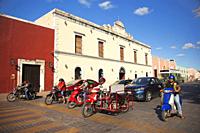 Motorcyclists in front of the colonial buildings at the historic center, Valladolid, Riviera Maya, Yucatan State, Mexico, Central America.