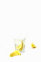 Glass of lemonade with splashing water on white background drink isolated healthy fresh drink concept.