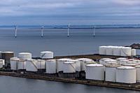 Copenhagen, Denmark Fuel storage tanks and wind turbines off the coastof the city in the port.