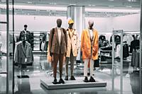 Mannequins Dressed In Men male Casual Clothes And coat jackets Clothes In Store Of Shopping Center. Stack clothes In Store Of Shopping Center. shelf d...