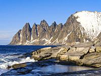 Coastal landscape at Tungeneset and the peaks Okshornan (devils teeth). The island Senja during winter in the north of Norway. Europe, Norway, Senja, ...