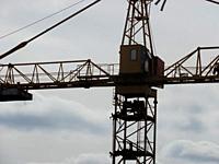 Metal crane tower for the construction of the multi-storey buildings.