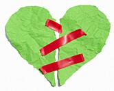 Torn heart made of green crumpled paper fastened with red electrical tape on a white background.