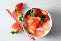 White bowl with natural yogurt and delicious strawberries.