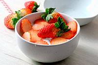 White bowl with natural yogurt and delicious strawberries.
