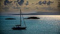 A lone yacht off the coast of Coll, Scotland.