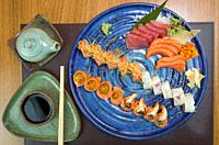 Combined of differents japanese sushi on a elegant blue plate.