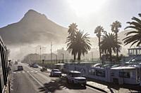 Victoria Road in Camps Bay with Lion's Head mountain in the background - Cape Town, South Africa.