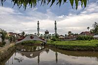 View of mosque from Rumah Keluarga Tjhia (Tjhia's villa), Singkawang, West Kalimantan, Indonesia  Rumah Keluarga Tjhia (also known as Rumah Tjhia) is ...