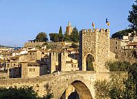 Besalu, Girona Province, Catalonia, Spain. Fortified bridge known as El Pont Vell, the Old Bridge, crossing the Fluvia river. Documents dating back to...