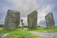 woman observing the menhirs, Megalithic Circle of Drombeg, - The Altar of the Druid-, Rosscarbery approximately from the year 150 a. c. , Ireland, Uni...