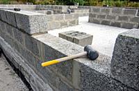 Mallet lies on part of the wall during the construction of a residential building.
