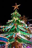 Perpignan's magical Christmas tree attraction, a dazzling spectacle of festive lights illuminating the night, casting a warm glow in the city.
