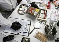 Police scientist examines seizures of adulterated fentanyl in crime lab, Conceptual Ima.