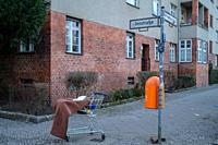Discarded shopping cart and other detrius on the streets of Berlin-Neukölln, Germany.