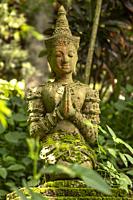 Thai stone statue at Wat Pha Lat (temple on the slanting rock) in Chiang Mai, Thailand. Wat Pha Lat became a popular resting place on the pilgrimage t...