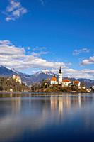 Bled lake with Bled catle, church and winter Julian Alps at background.