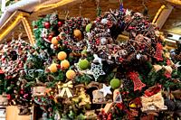 Santa Llucia Market's enchanting corner: A stall brimming with exquisite Christmas wreaths, adding festive charm to Barcelona's holiday spirit.